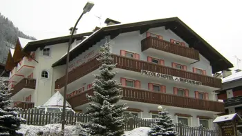 A look at the hotel's snowy exterior, with vast mountains and trees across the background.