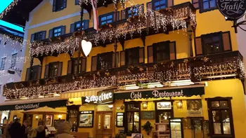 A view of the hotel's exterior, with warm lighting and clear skies.